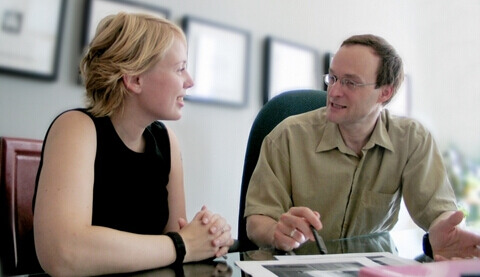 two casually dressed business people meeting